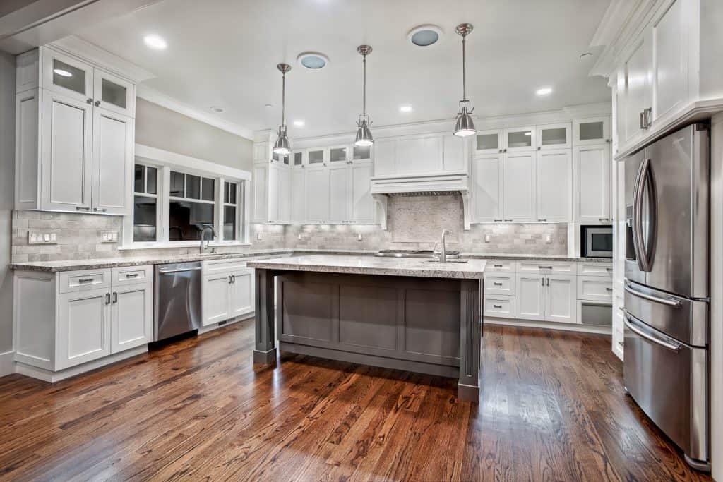 Sleek pendalent lighting in this custom kitchen with a center island