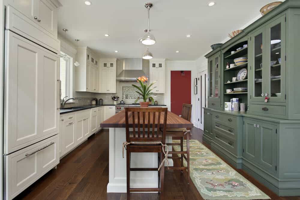 Custom styled kitchen with wood butcher block island and dark recycled countertops