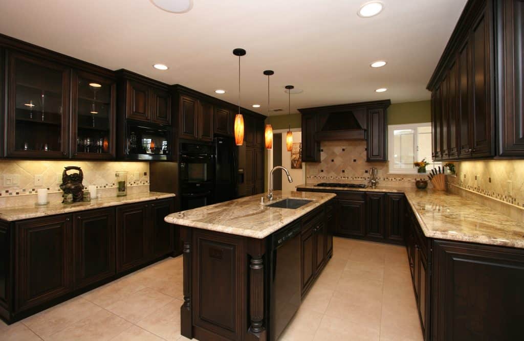 Dark kitchen cabinets with light marble countertops