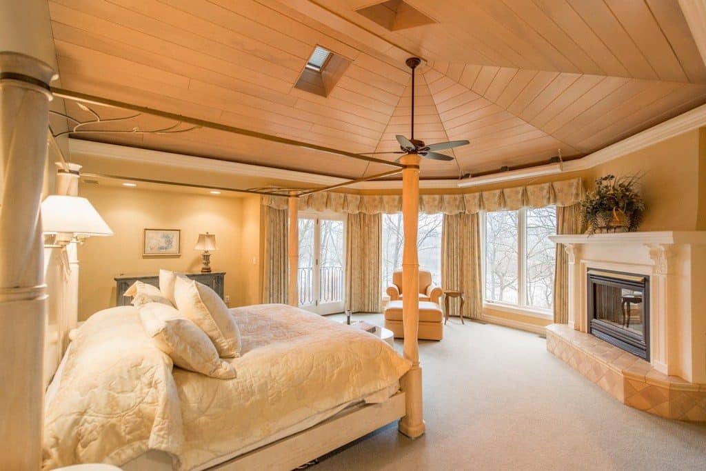 A luxury master bedroom with tongue and groove ceiling 