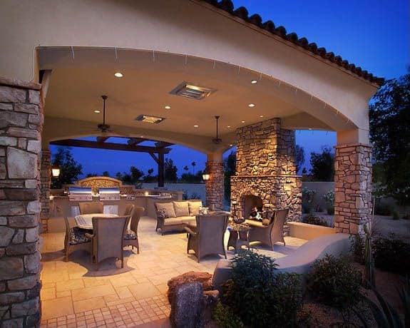 Mediterranean style backyard patio design with overhang