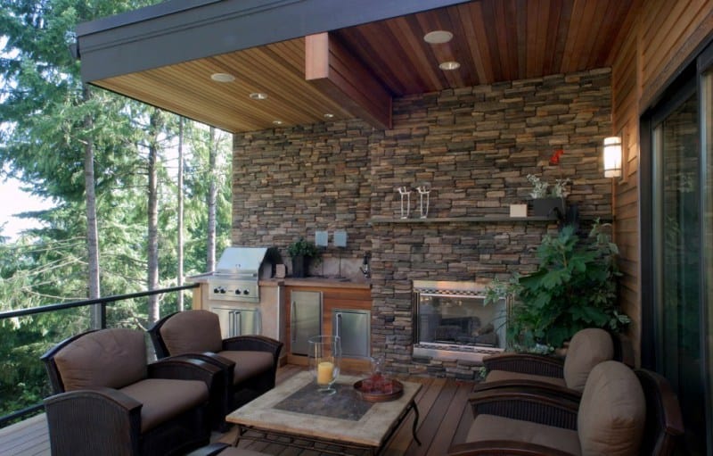 Rustic backyard patio with stone veneer wall