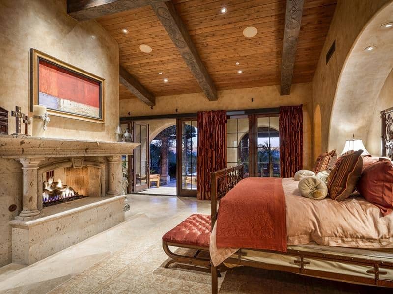 Rustic Master Bedroom with limestone tile floors & High ceiling