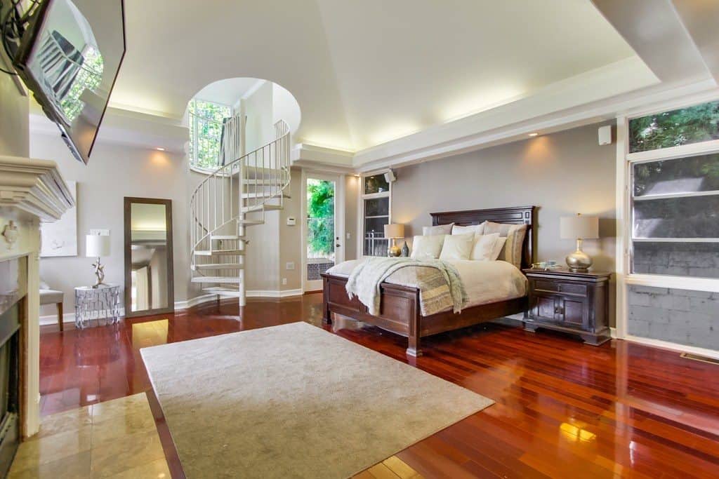 Beautiful modern master bedroom profesionally design featuring a spiral staircase