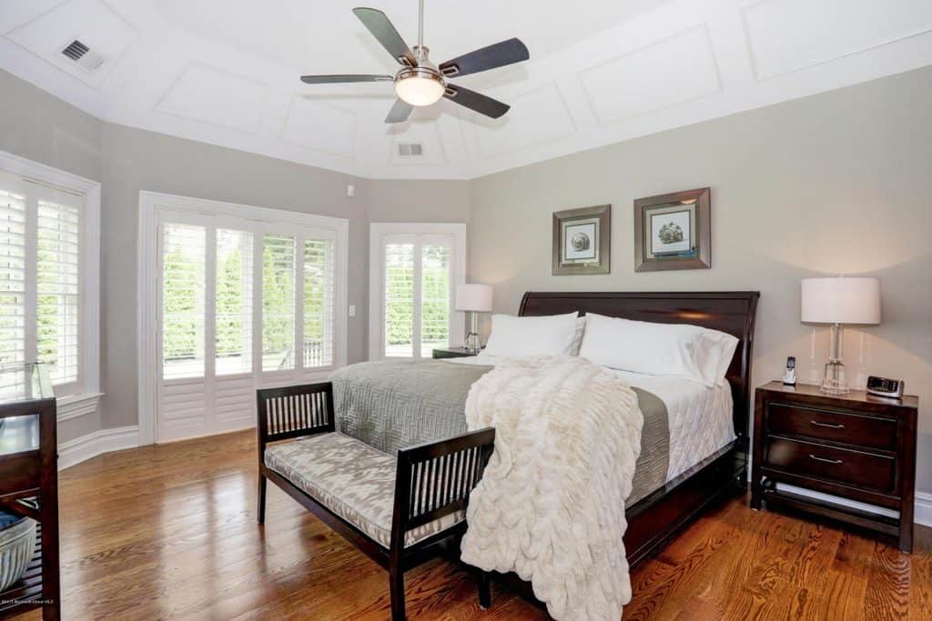 Colonial styled master bedroom with light color scheme