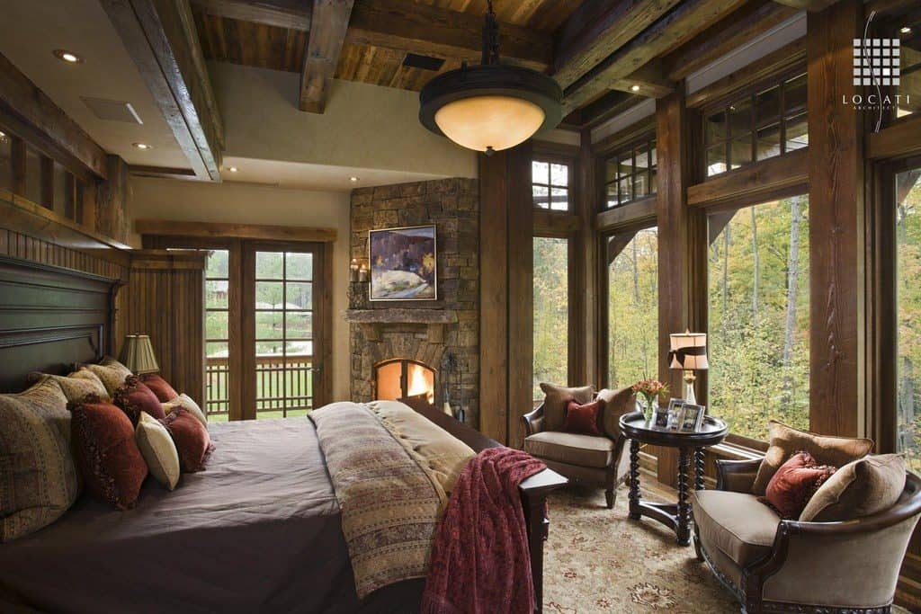 Country style master bedroom with reclaimed wood, exposed wood beams, fireplace and great color scheme