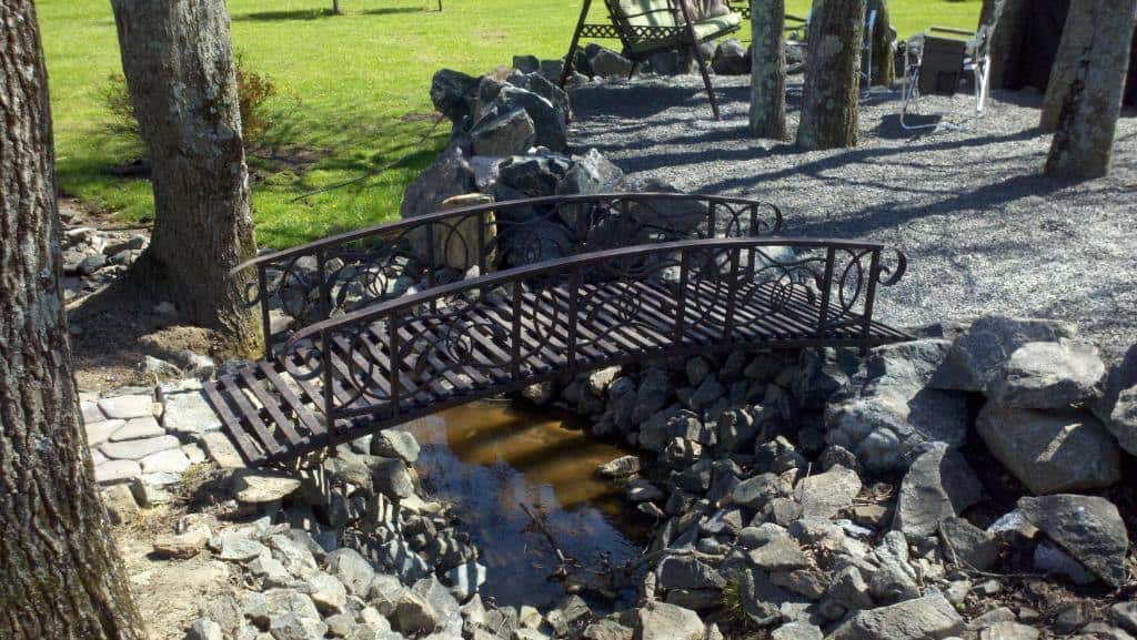 amazing metal bridge add character to garden