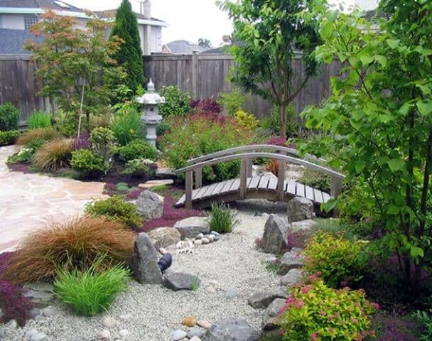 peaceful backyard garden bridge and gravel
