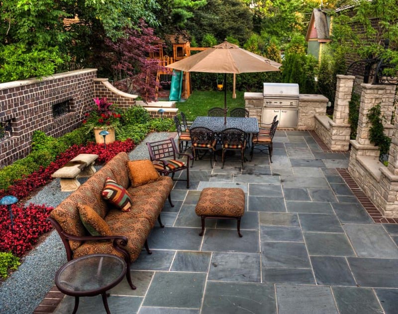 Beautiful slate patio design with built in cooking area and fire pit