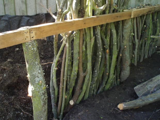 DIY raised garden bed with branches