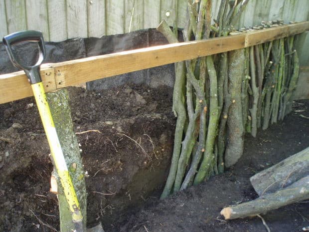 DIY raised garden bed with branches